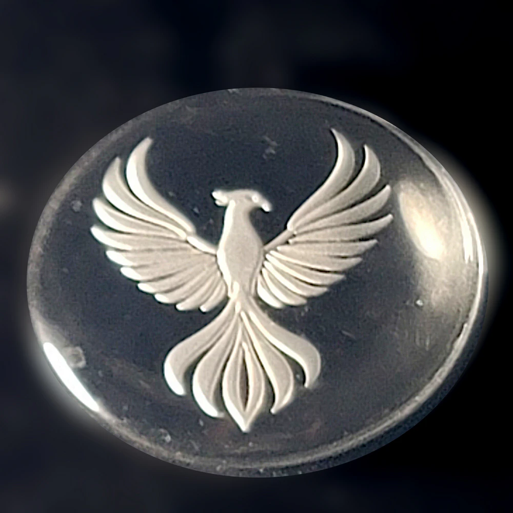 phoenix cabochon, rebirth symbol, resilience gift, mythical bird design, inspirational collectible, renewal symbol art, minimalist mythology decor, rising phoenix token